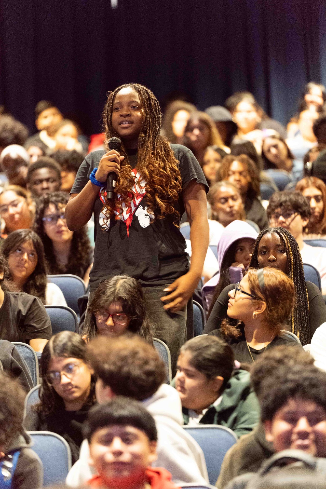 A student asking a question during the assembly