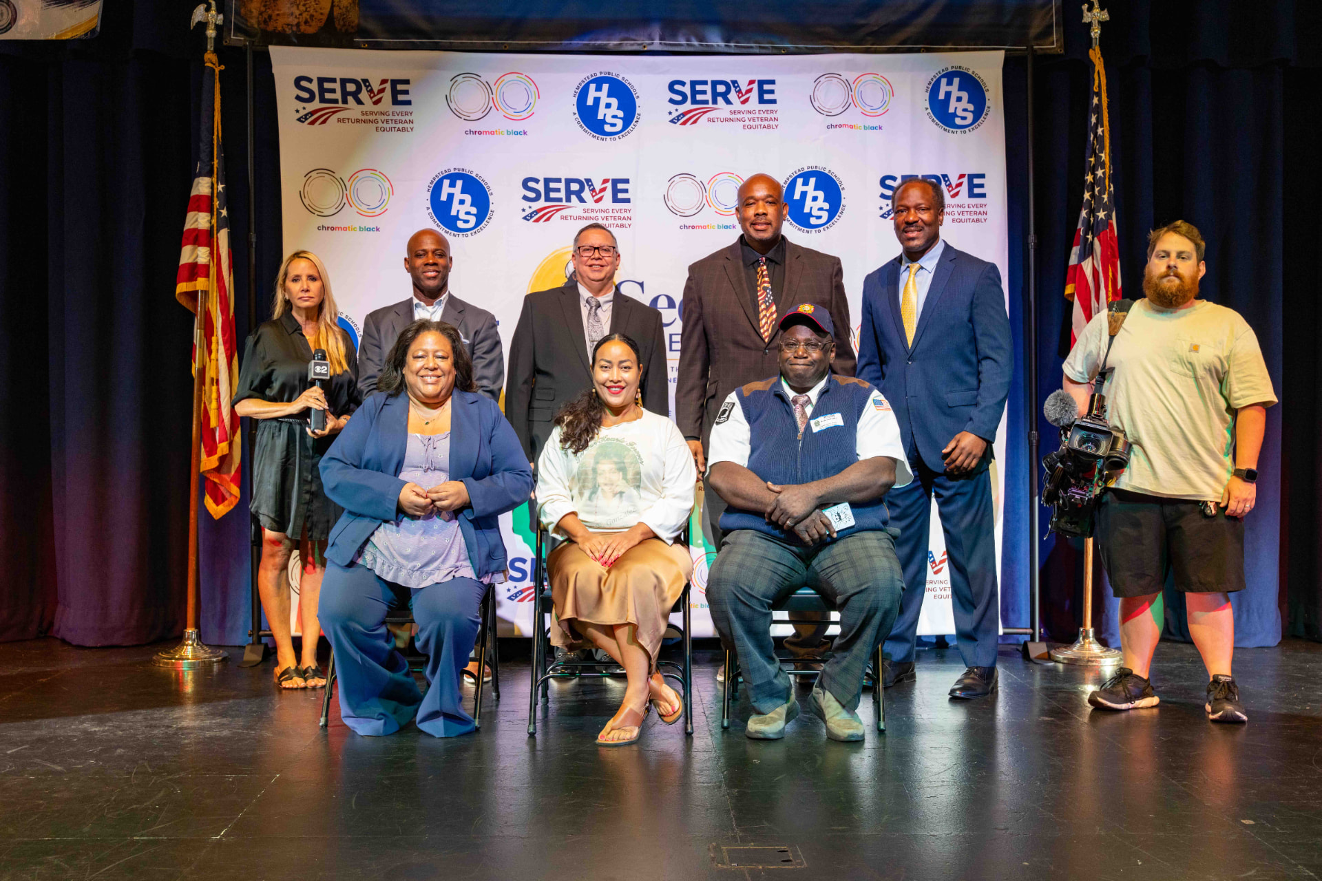 Panelists and Hempstead High School leadership on stage at the commemoration assembly