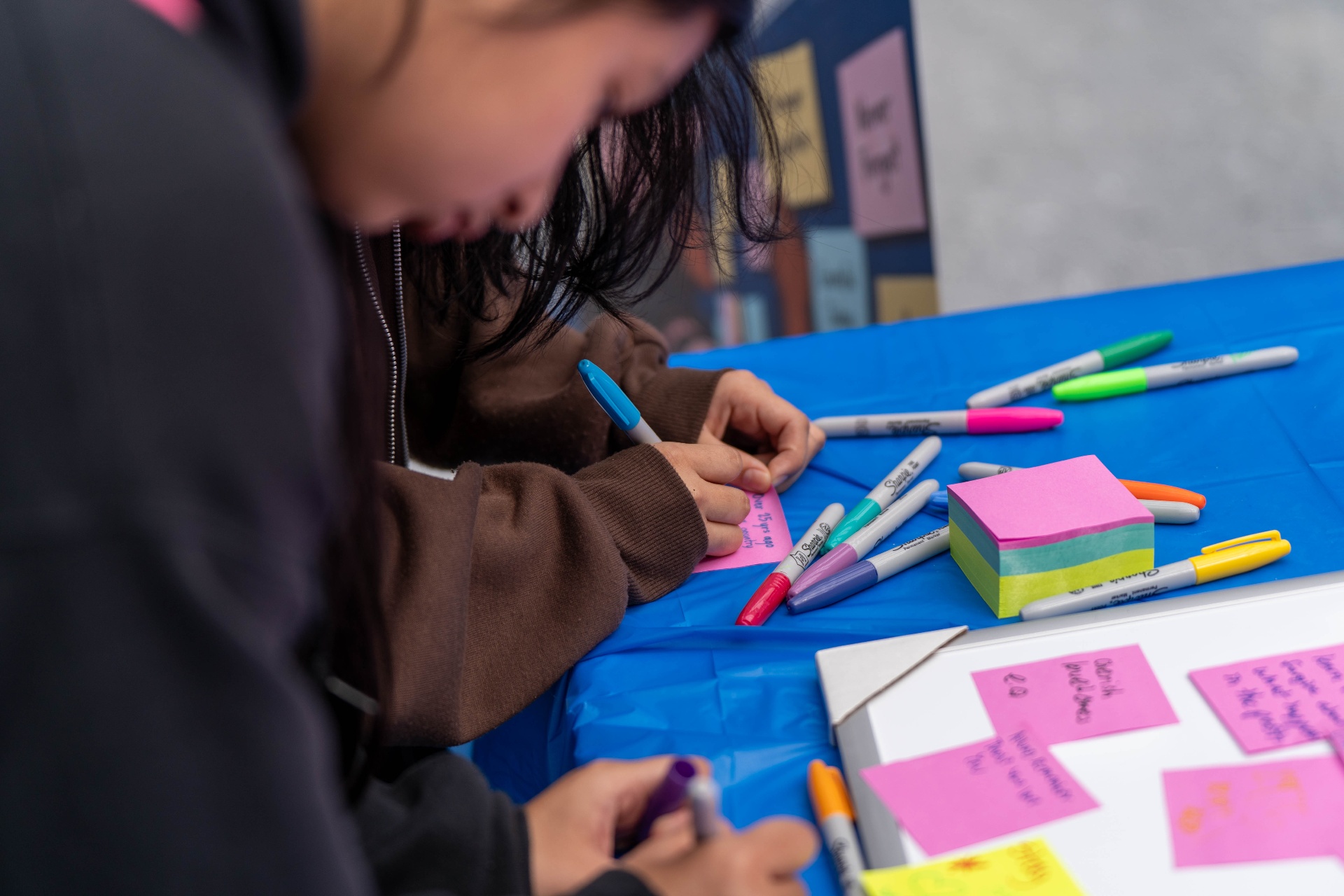 Students writing notes for the Wall of Remembrance & Gratitude