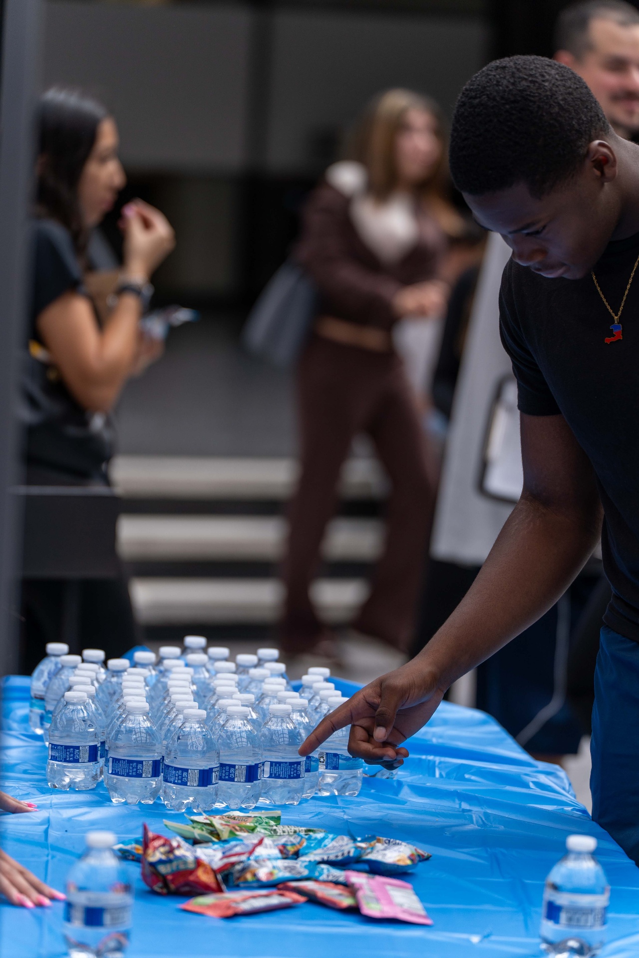 A student at the table of water and snacks