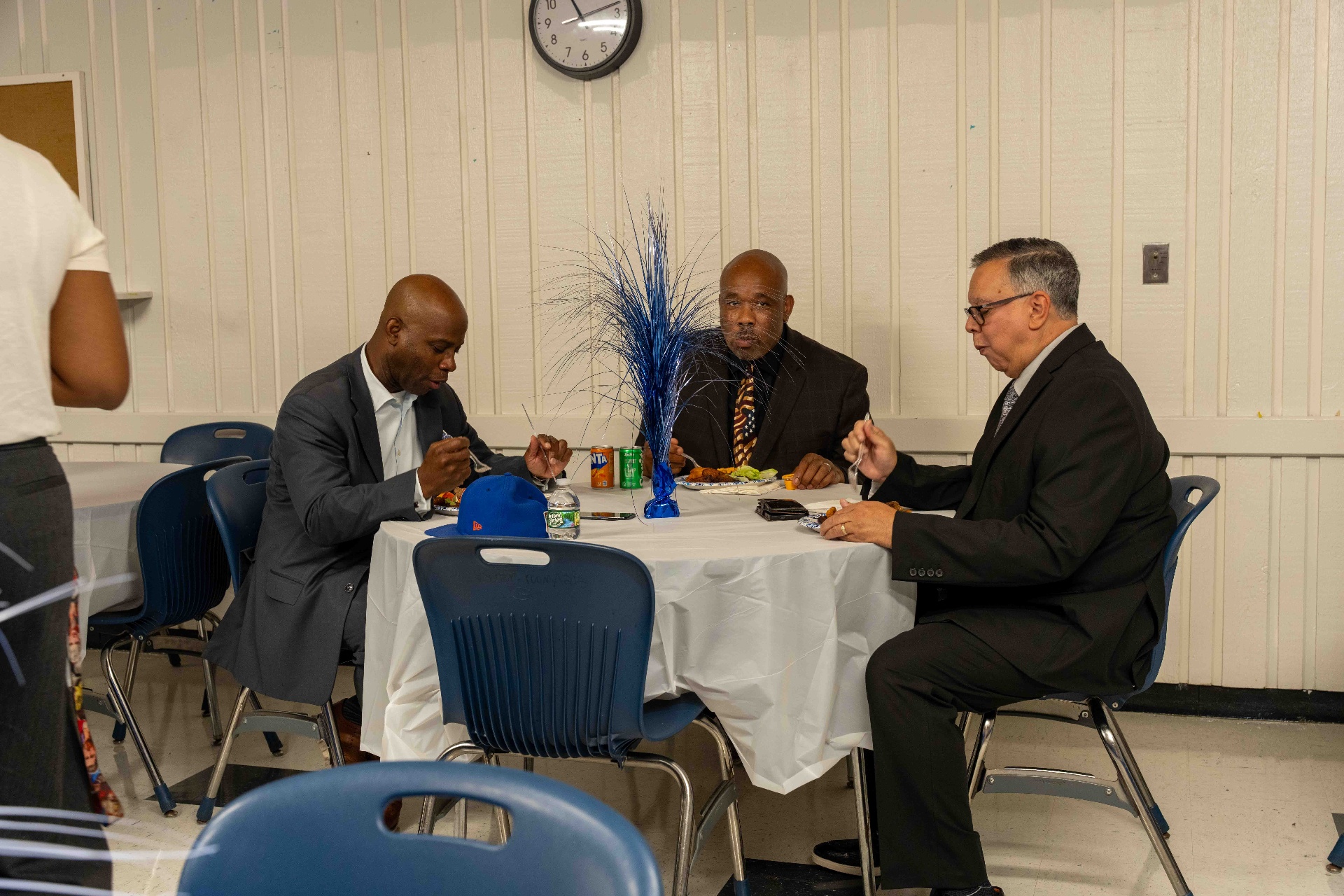 Three Hempstead Union Free School District leaders seated at a round table during the Hempstead High School Lunch & Learn