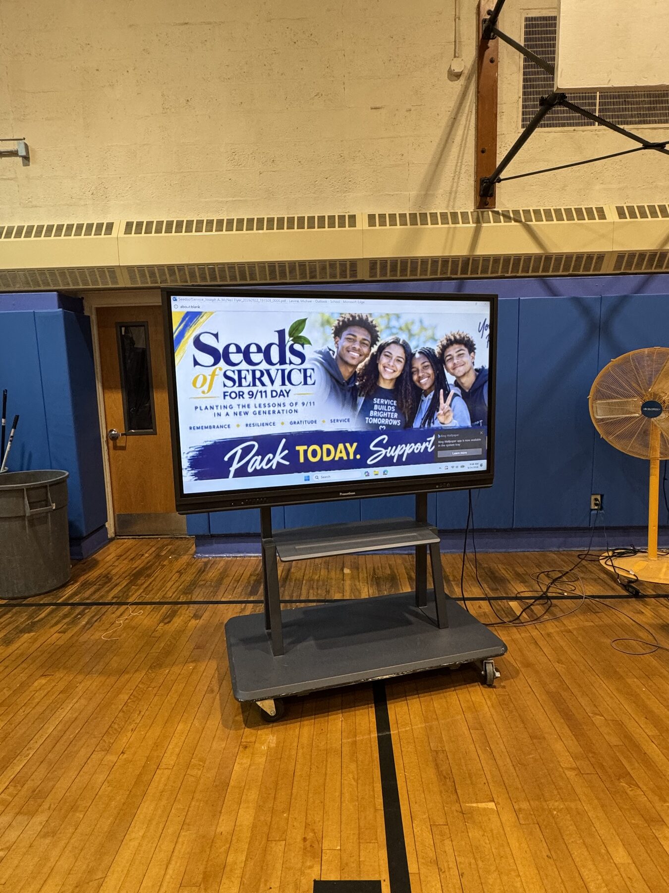A digital display in the Joseph A. McNeil Elementary School gymnasium promoting Seeds of Service for 9/11 Day